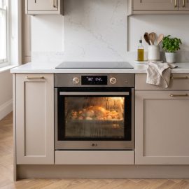 a modern LG built-in electric oven operating during cooking inside a stylish Chelsea, London apartment kitchen