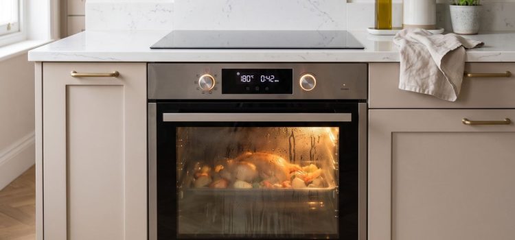 Why The Glass In Your Oven Door Turns Cloudy And Can It Ever Look New Again a modern LG built-in electric oven operating during cooking inside a stylish Chelsea, London apartment kitchen
